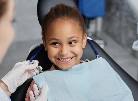 A happy child getting a dental exam