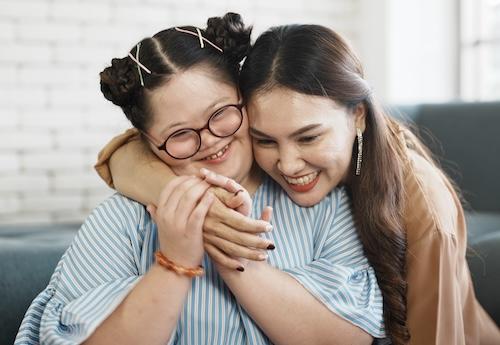 A mother hugging her daughter with special needs