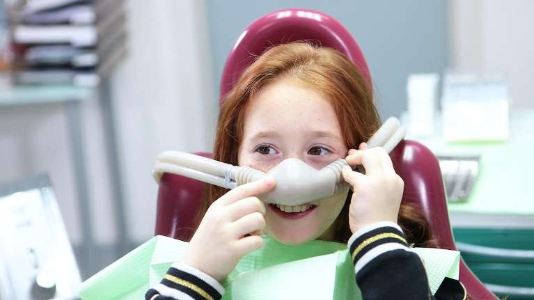 A child receiving oral sedation at the dentist