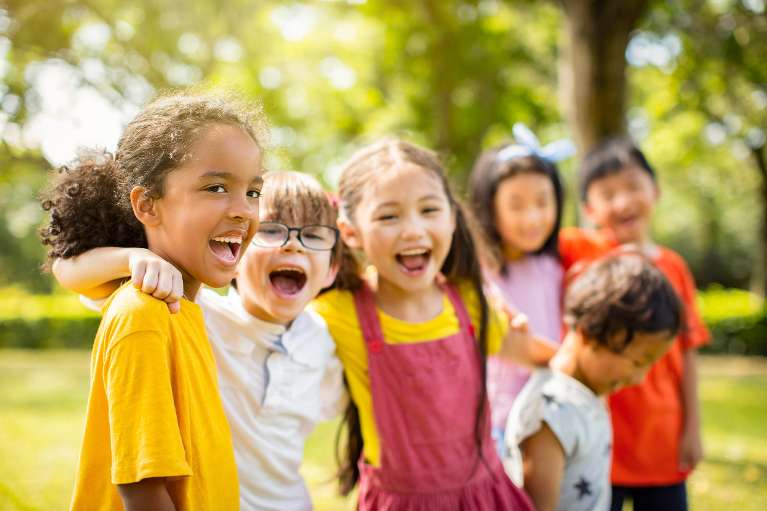 A group of laughing kids playing in the park